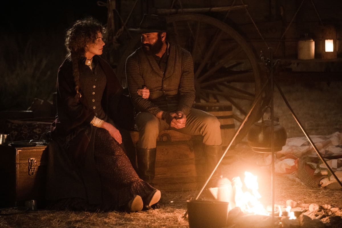 Faith Hill and Tim McGraw in a campfire scene of the Paramount+ show 1883