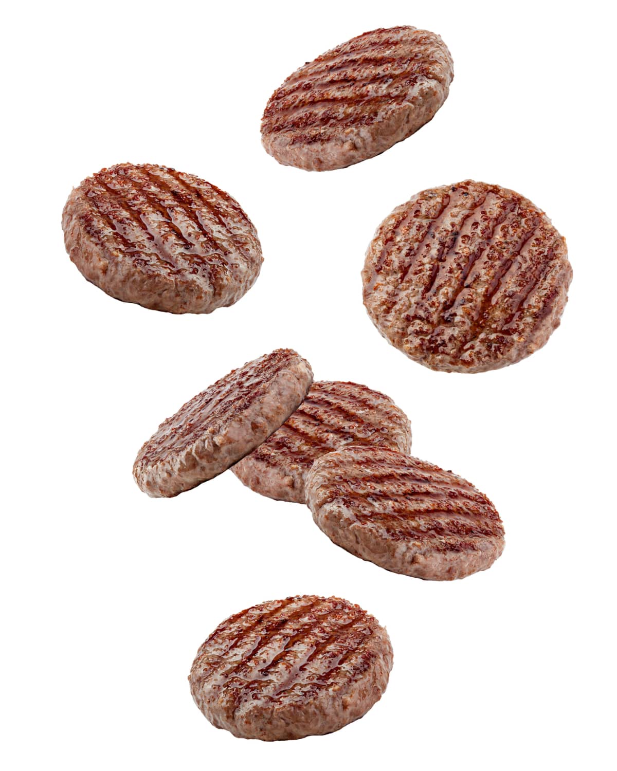 Fresh raw burger patties and falling on white background