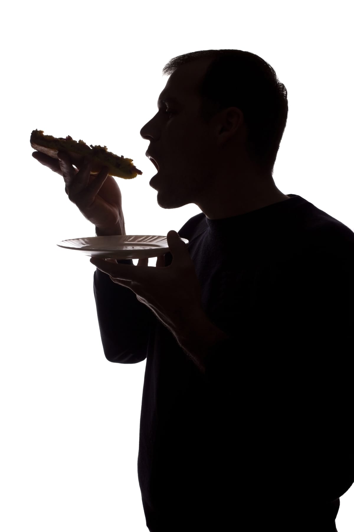 Portrait of a young man eat a pizza in hand.