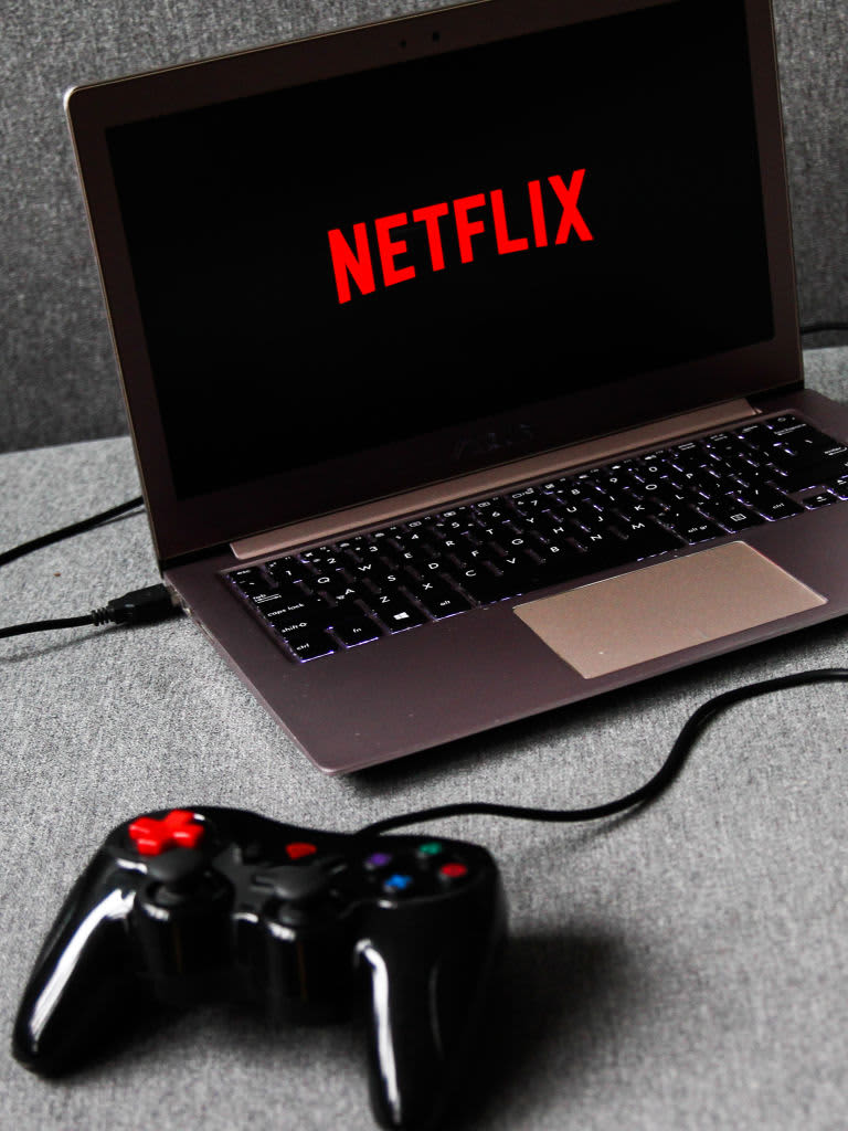 Netflix logo is displayed on a mobile phone screen with Netflix website in a background for illustration photo. Krakow, Poland on January 23, 2023. (Photo by Beata Zawrzel/NurPhoto via Getty Images)