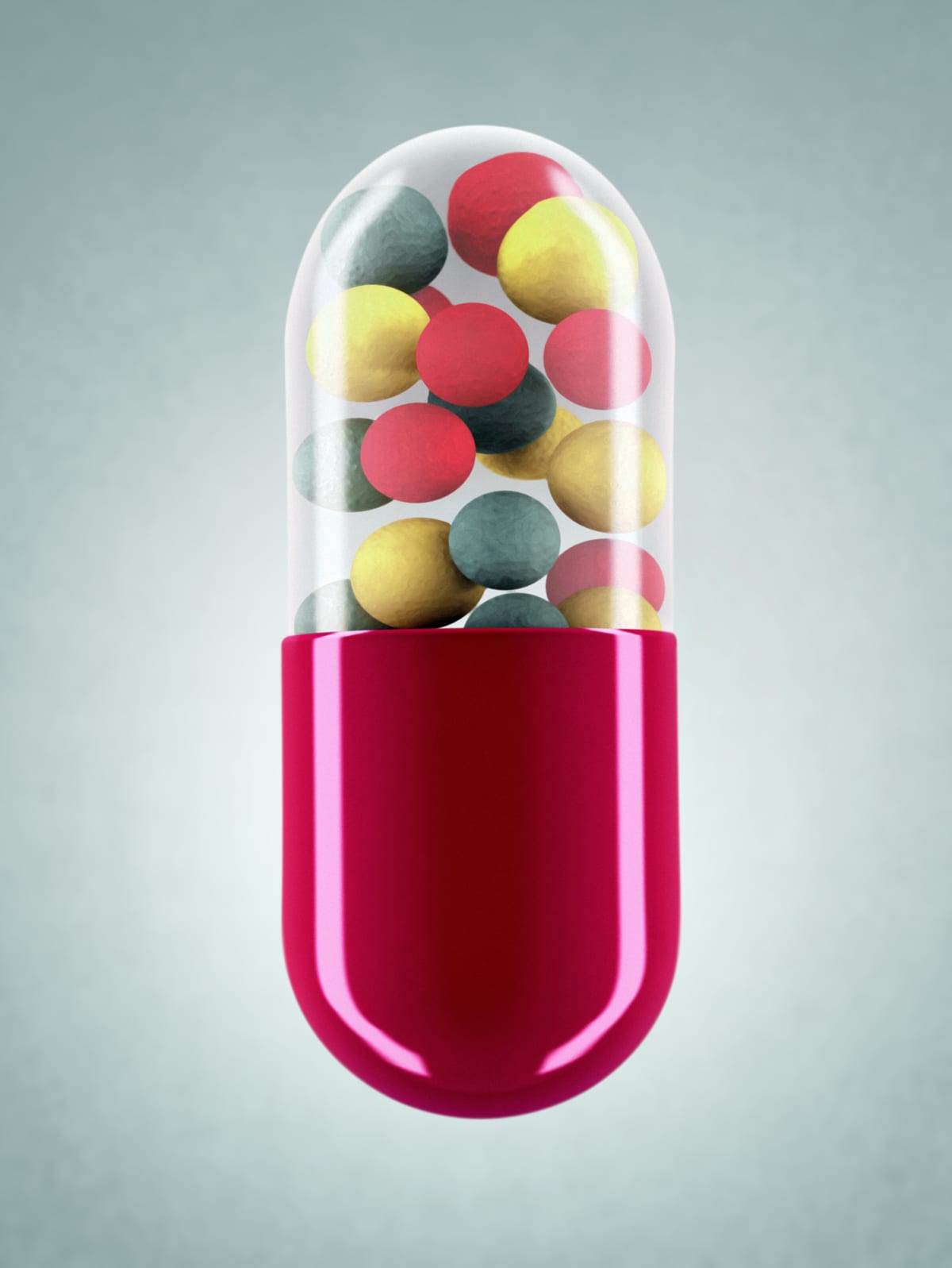 A pill capsule floats against a blue background. The red pill contains a variety of colourful powerful drugs.