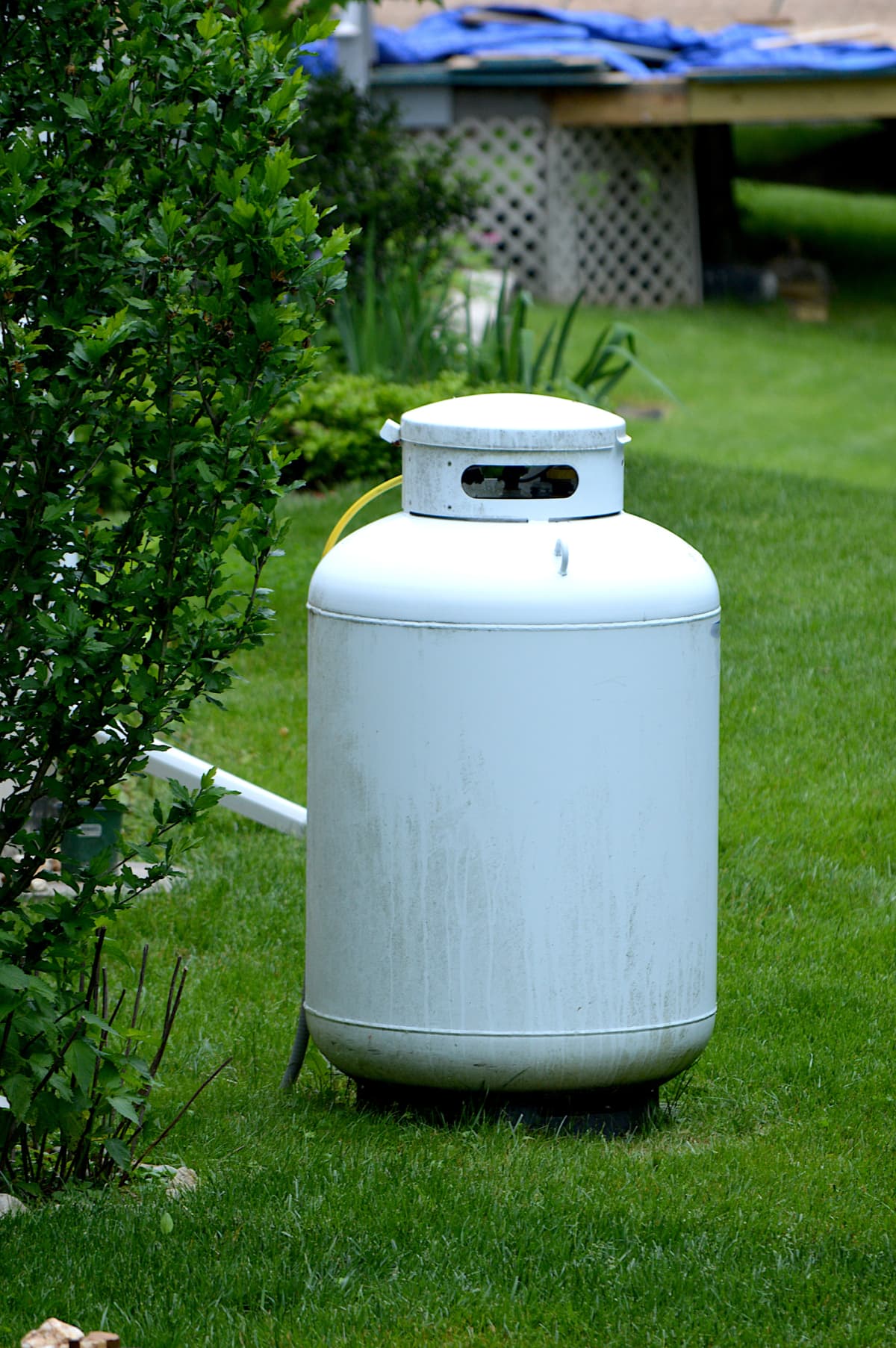 A propane tank placed on a lawn