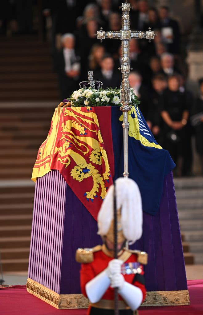 A member of the King's Body Guards of the Honourable Corps of Gentlemen at Arms stand guard around the coffin of Queen Elizabeth II