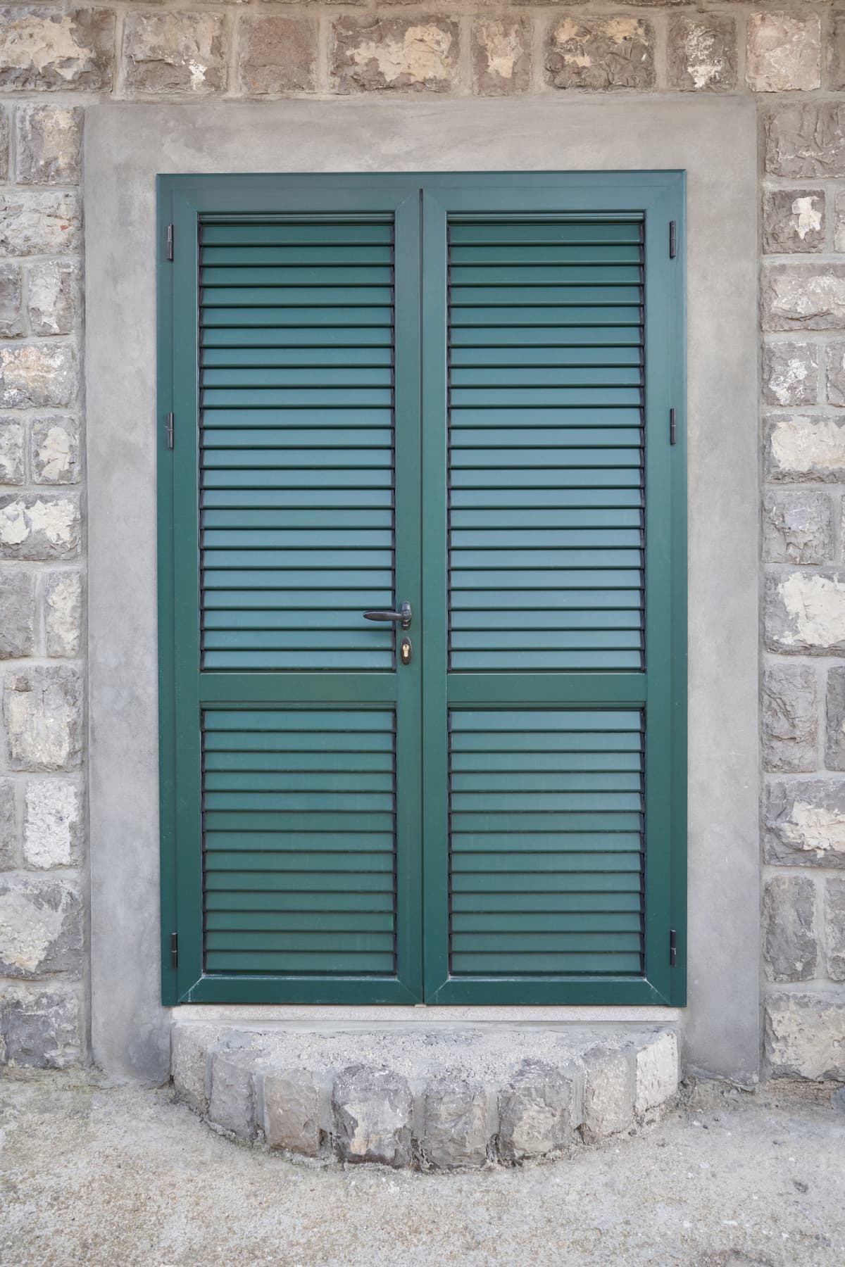 Green door with matching trim at a house entrance