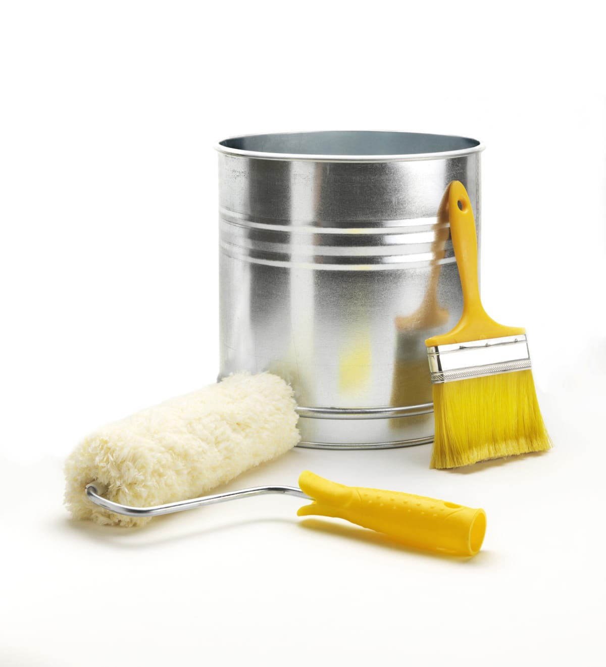 Paint roller, paint brush, and paint bucket on white background