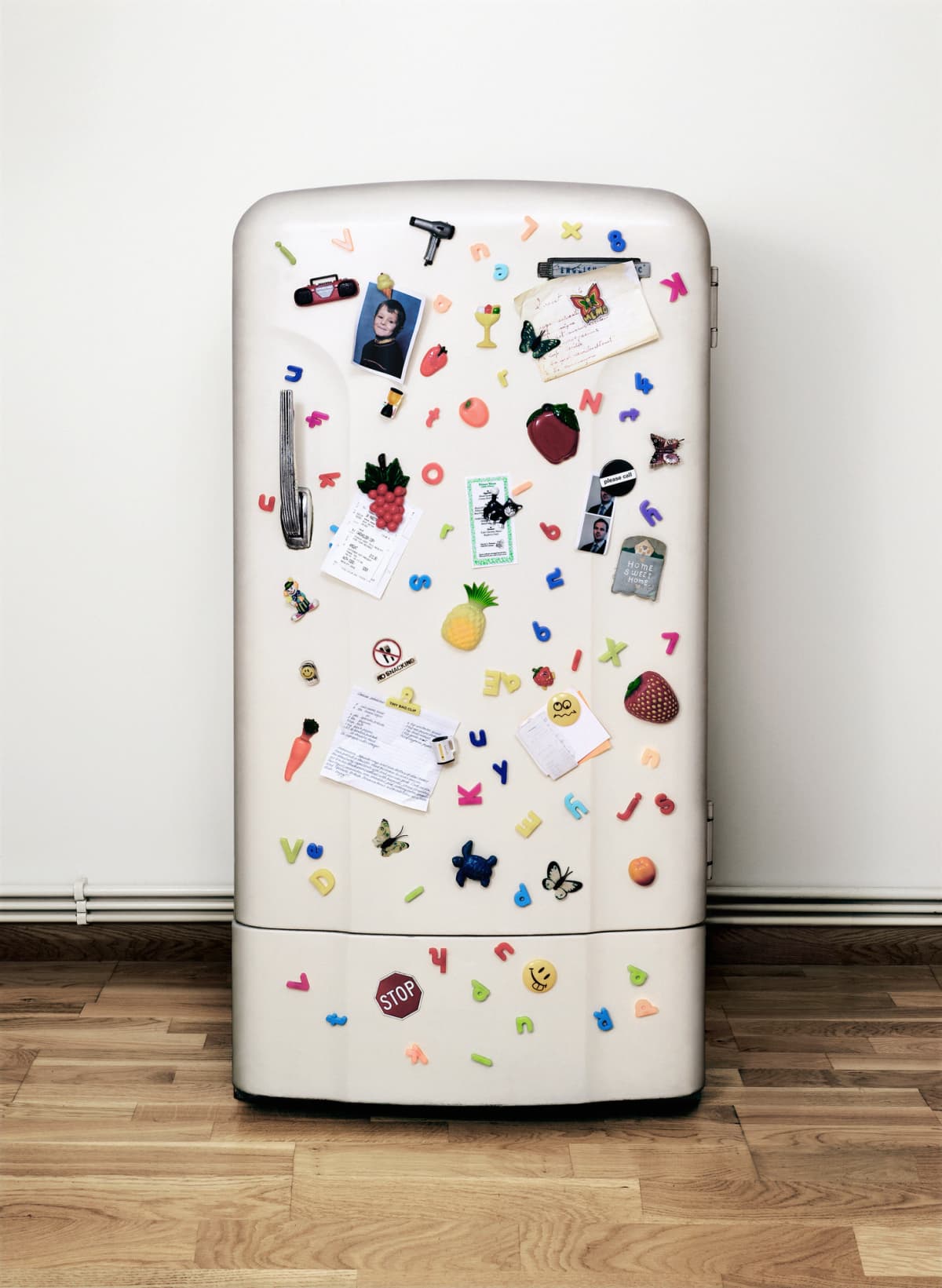 A fridge covered in notes, magnets, and photographs