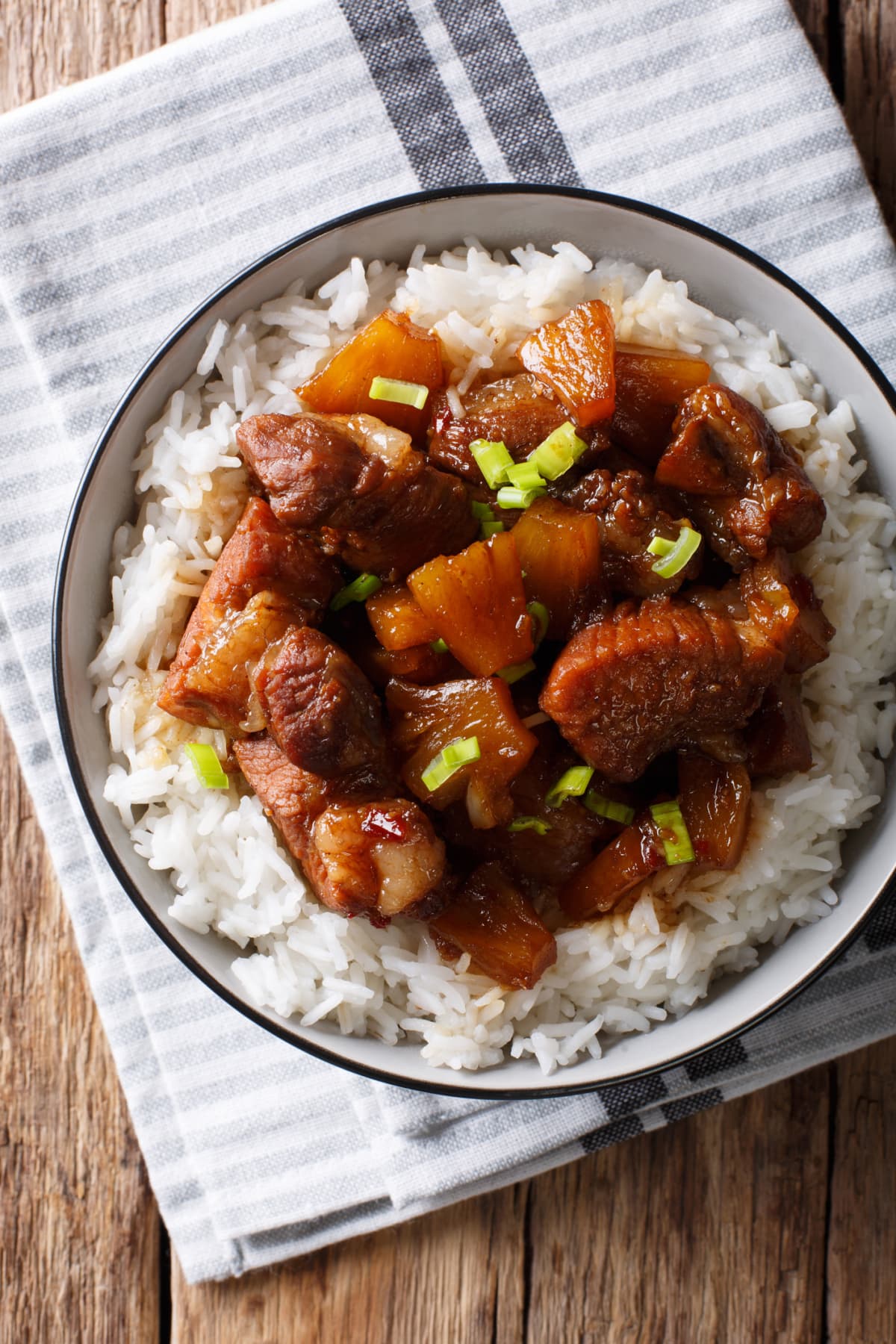A close-up view of pork adobo with brown rice gourmet