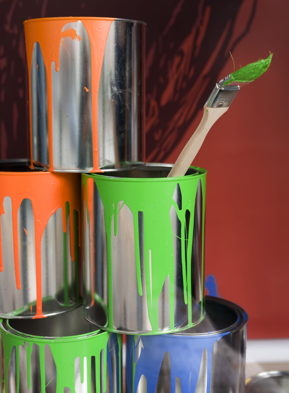Painting equipment with paint cans and paintbrush.