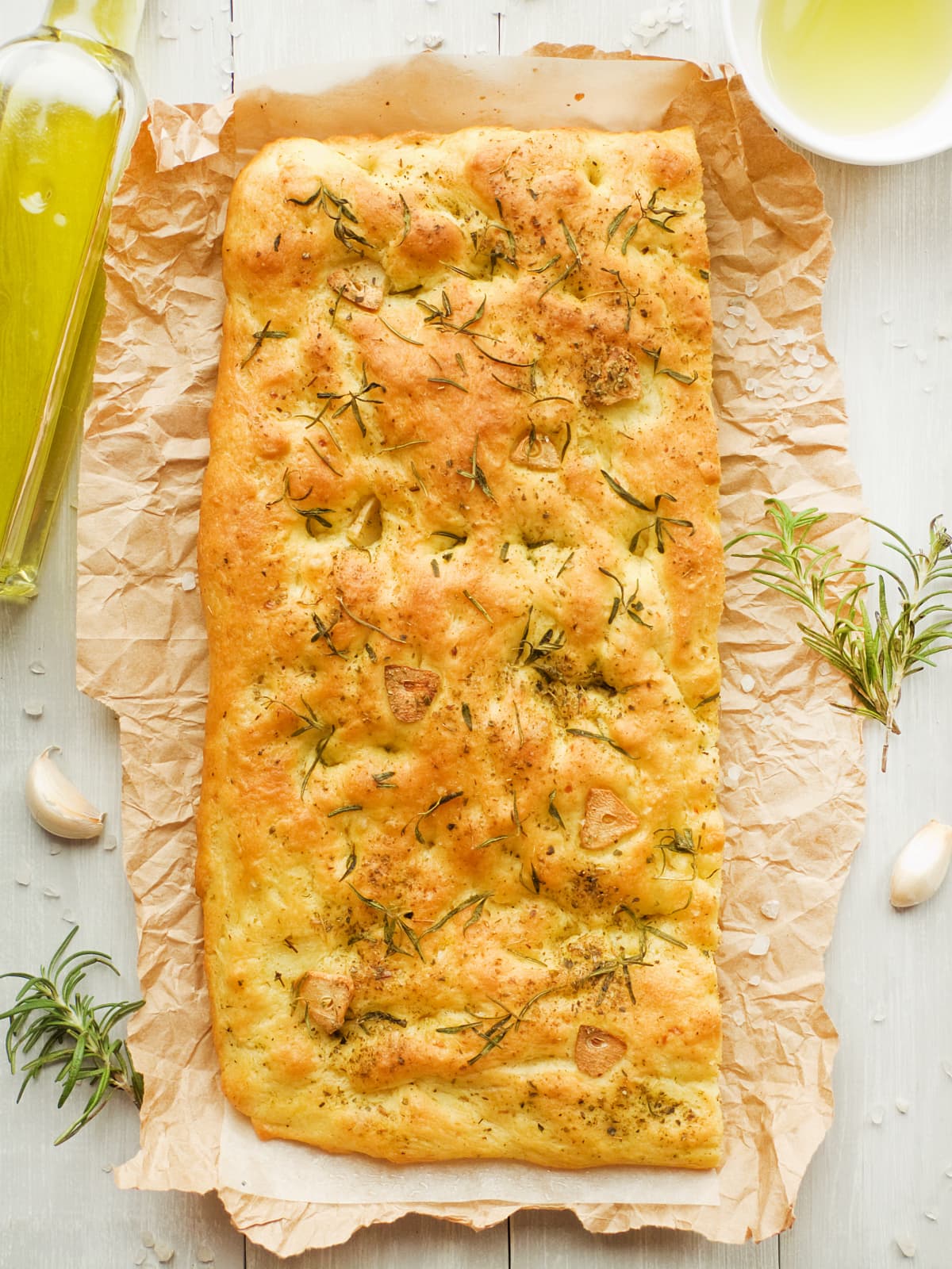 Italian focaccia bread with rosemary, garlic, cherry tomatoes and olive oil. Shallow dof.