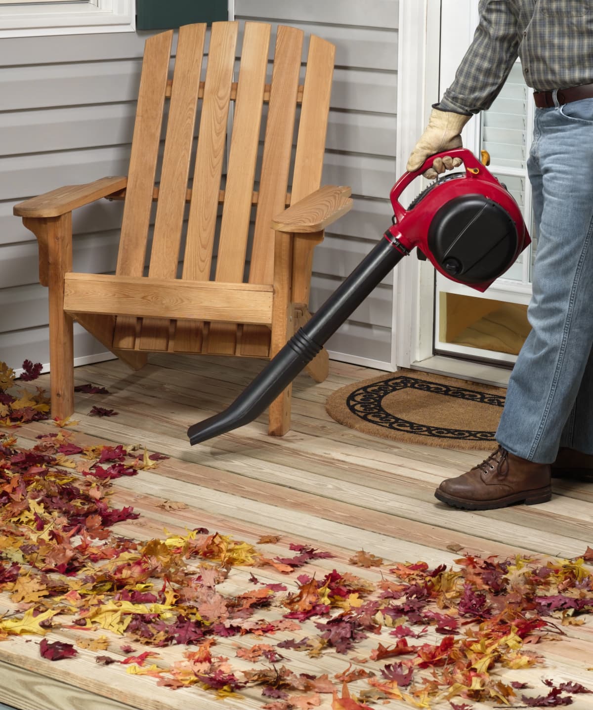 Leaf blower blowing leaves on a deck