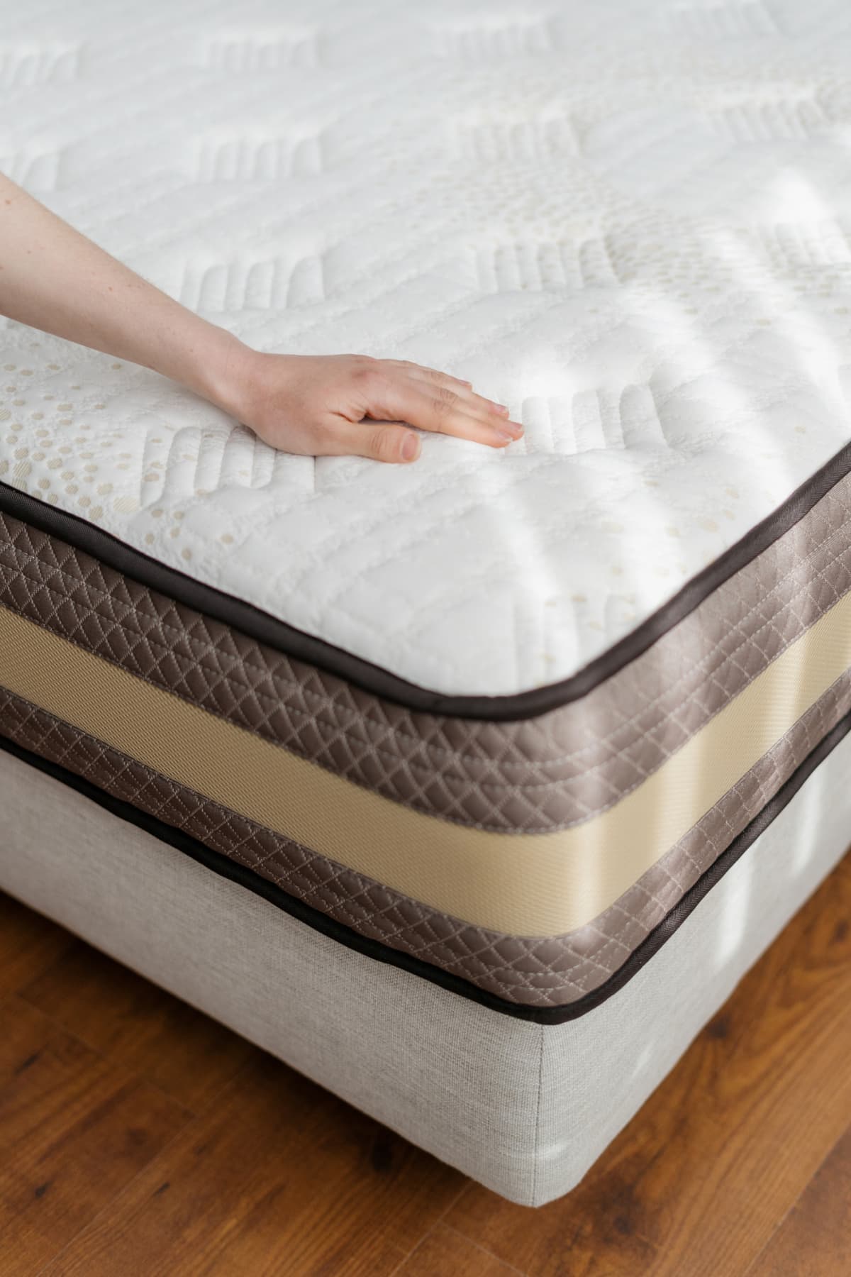 A person inspecting the mattress for its softness