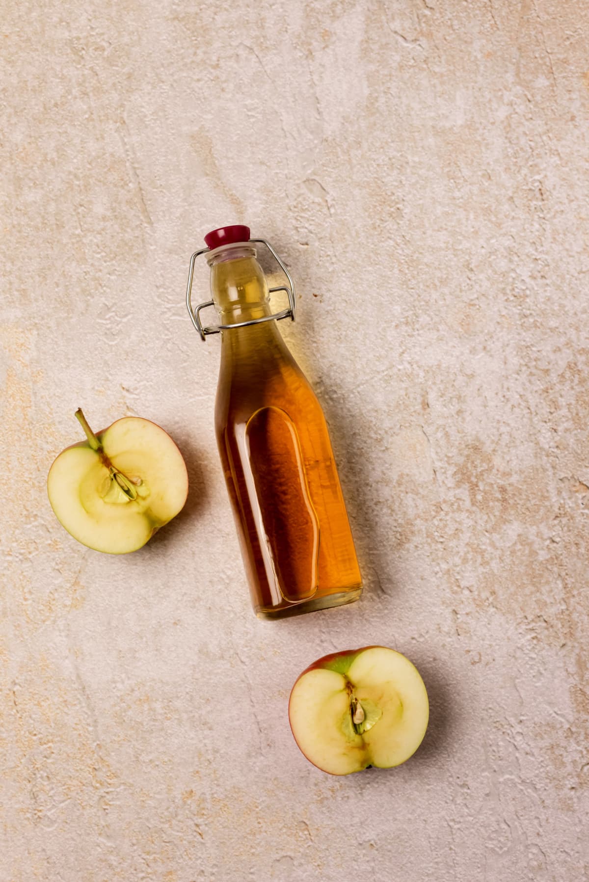 Apple juice Bottle next to half apples