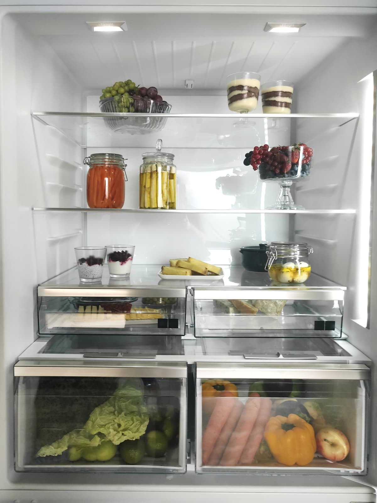 Vegetables and jars inside the refrigerator