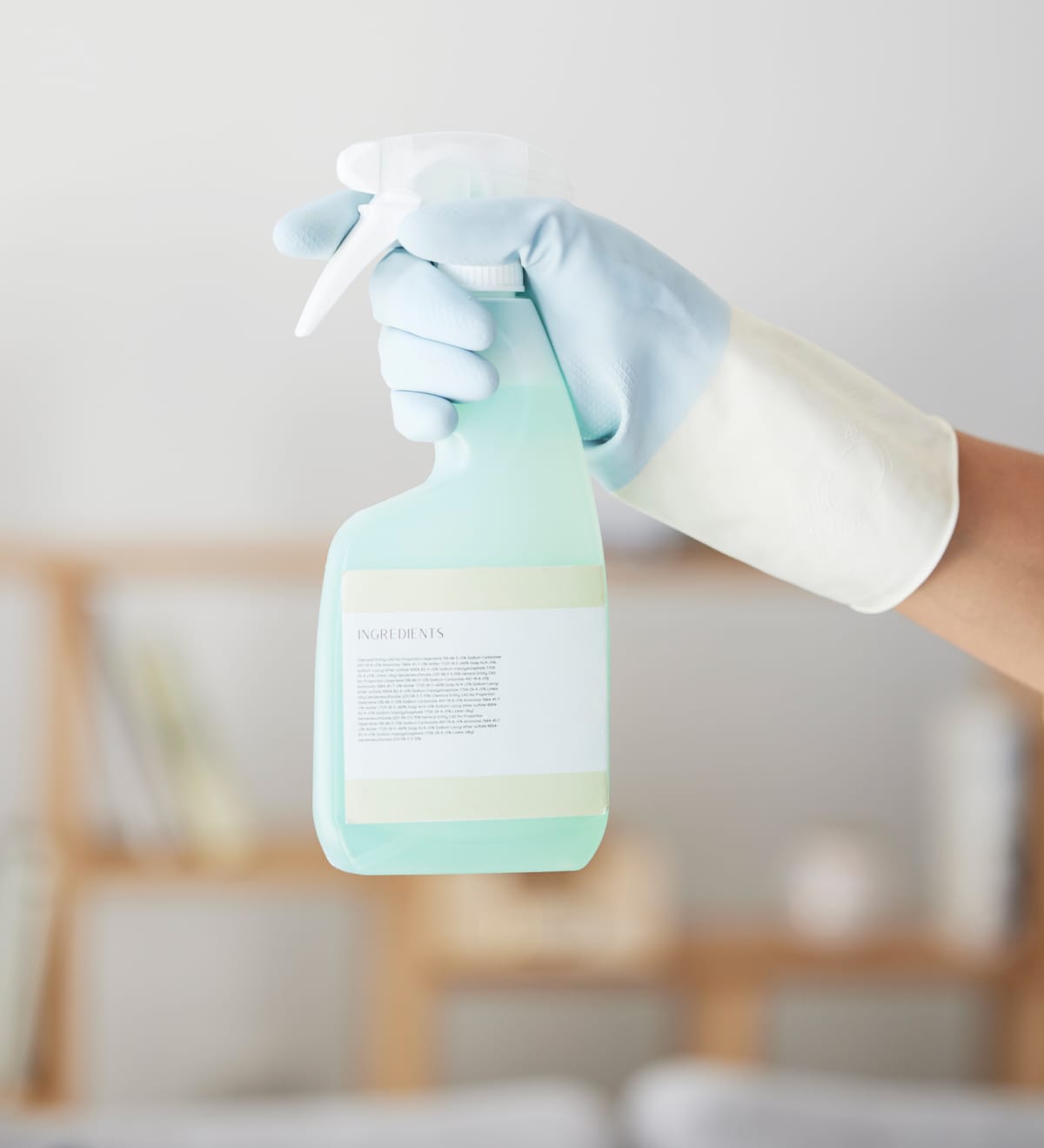Cleaning, spray bottle and hands of woman in home for bacteria, safety and sanitary. Hygiene, chemicals and housekeeping service with cleaner and disinfection product for germs, dirt and domestic