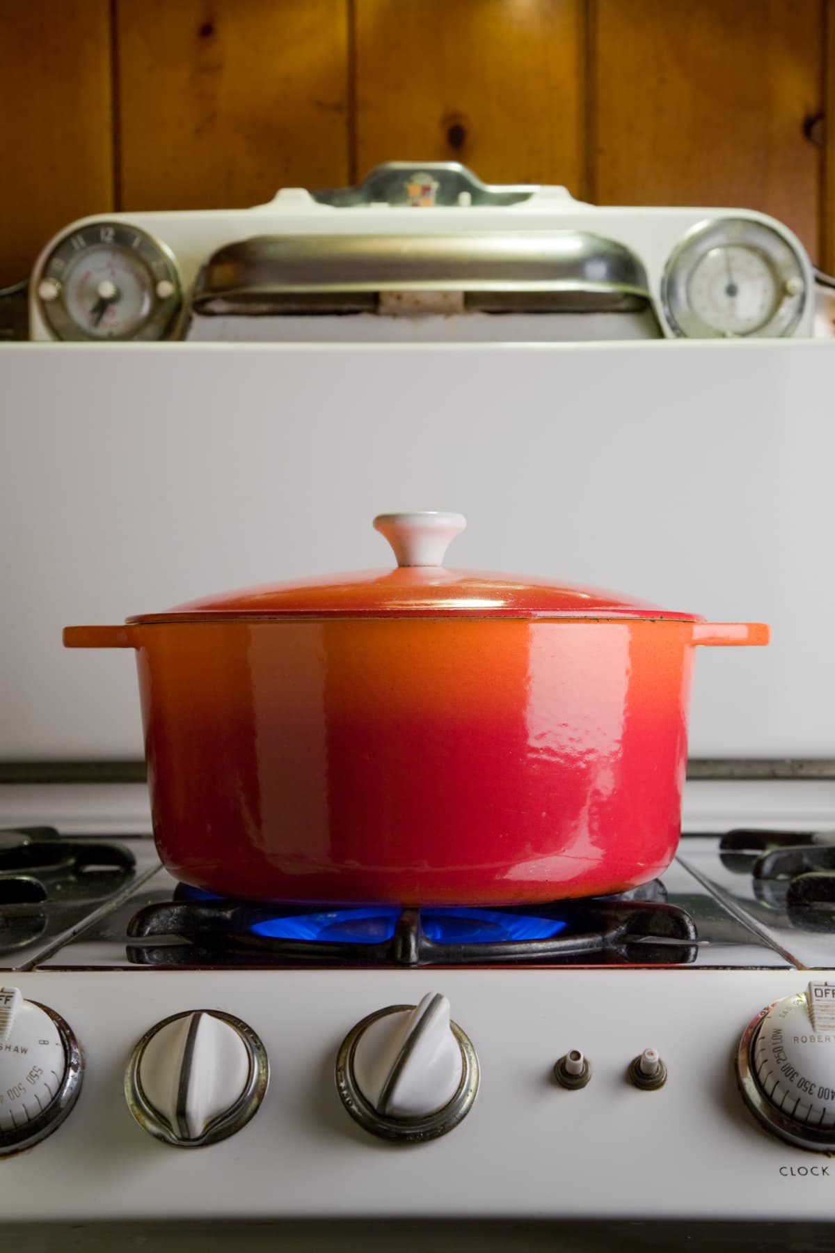 Red pot heating up on a stovetop