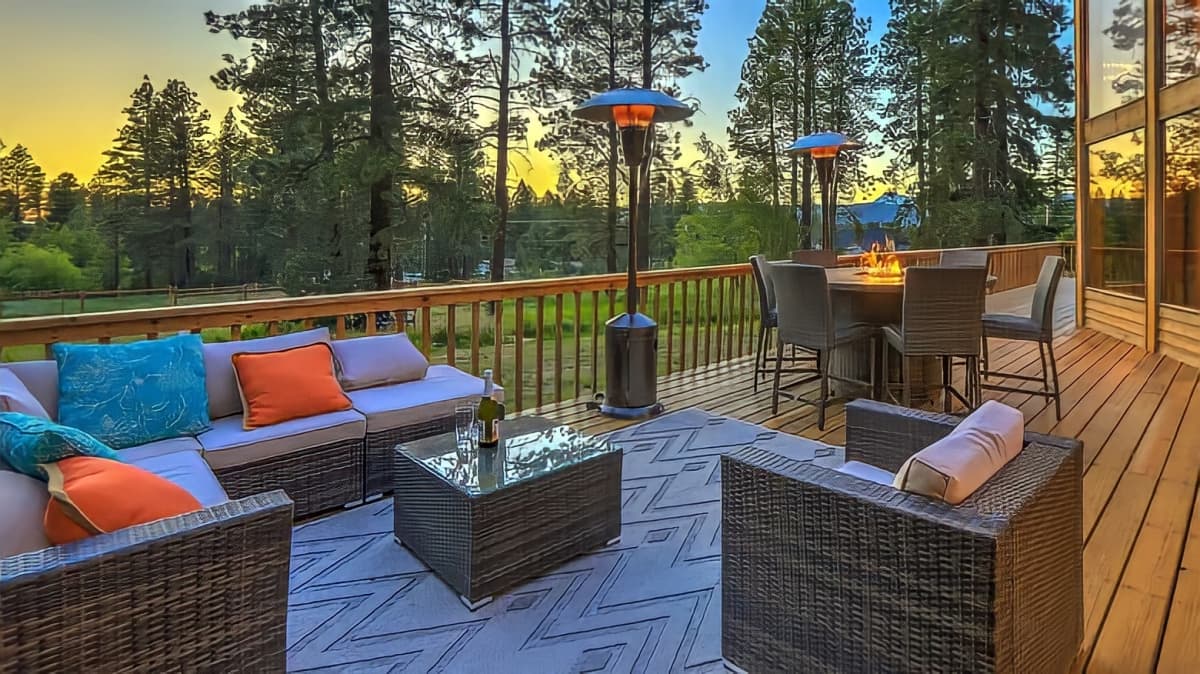 Outdoor patio with rug, heat lamps, and fire pit