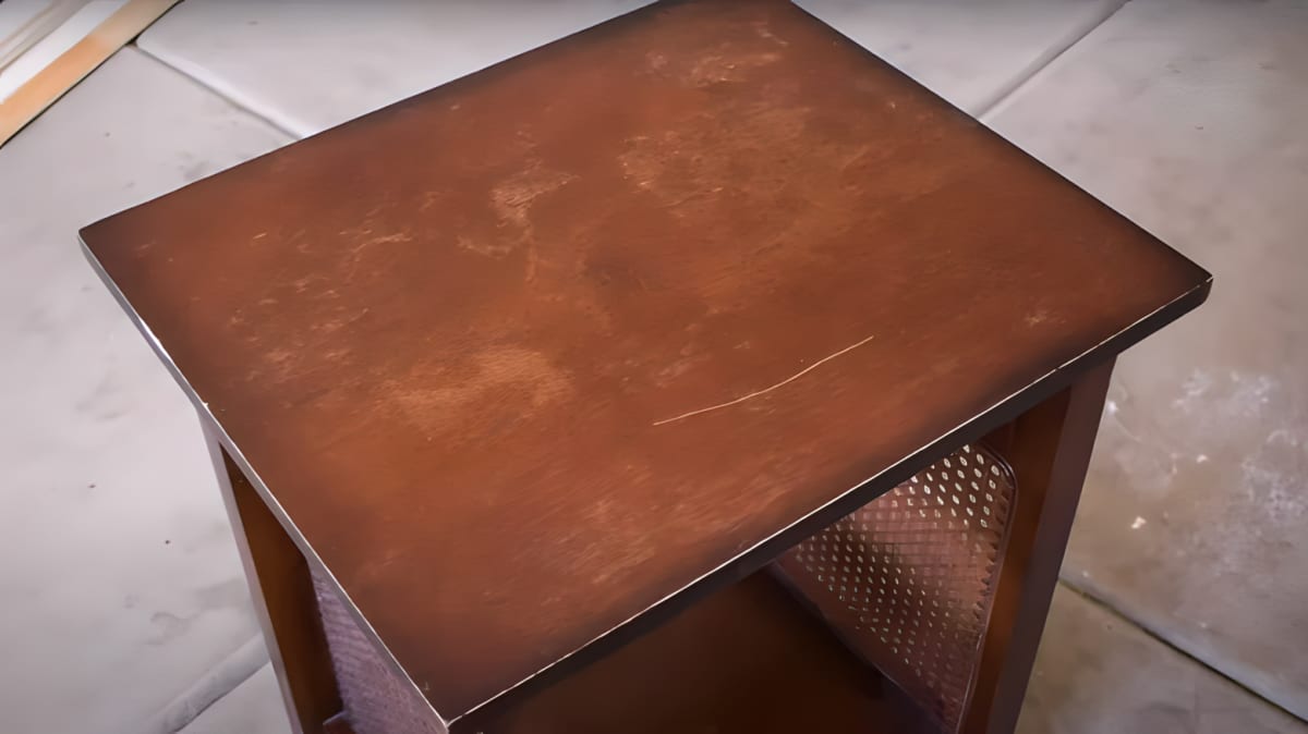 A wooden table with a scratch
