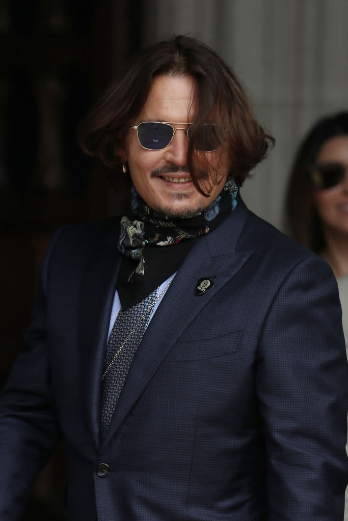 Actor Johnny Depp wipes an eye during his testimony at the defamation trial against his ex-wife Amber Heard, at the Fairfax County Circuit Courthouse in Fairfax, Virginia,  April 20, 2022. - Depp is suing ex-wife Heard for libel after she wrote an op-ed piece in The Washington Post in 2018 referring to herself as a public figure representing domestic abuse. (Photo by EVELYN HOCKSTEIN / POOL / AFP) (Photo by EVELYN HOCKSTEIN/POOL/AFP via Getty Images)