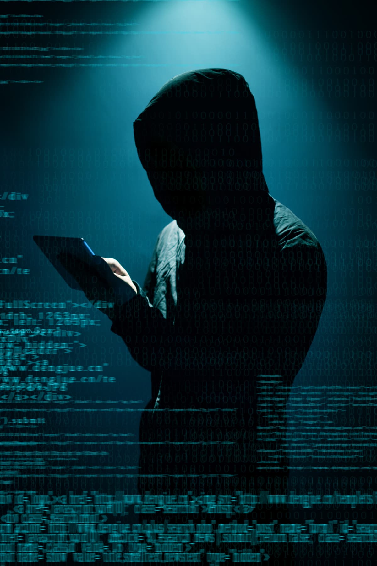 A hooded hacker on a device with lines of code surrounding the individual