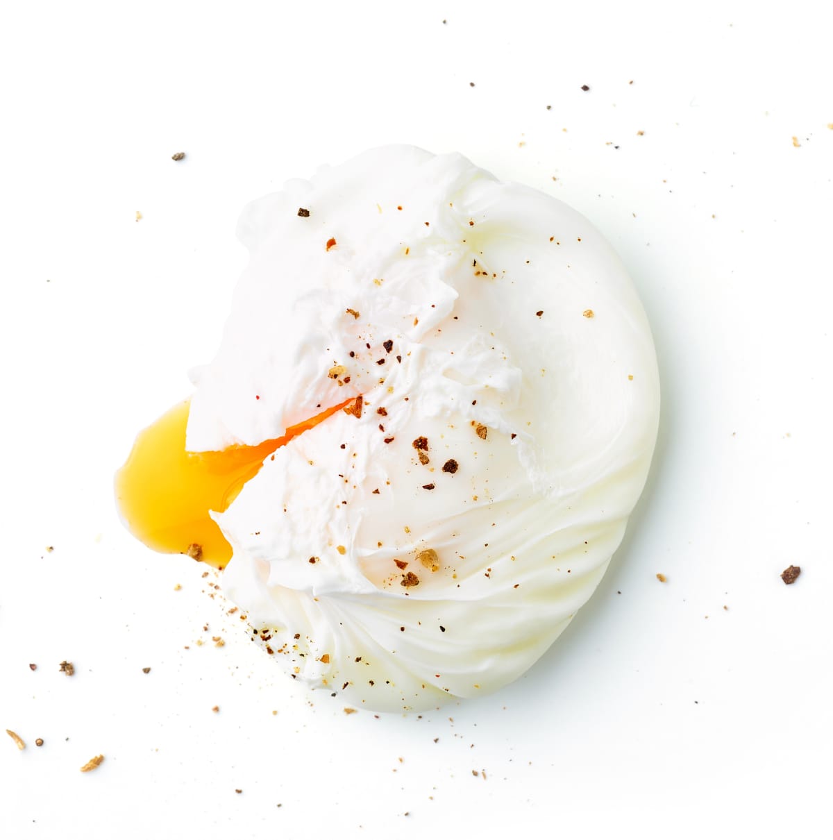 poached egg with runny yolk on white background