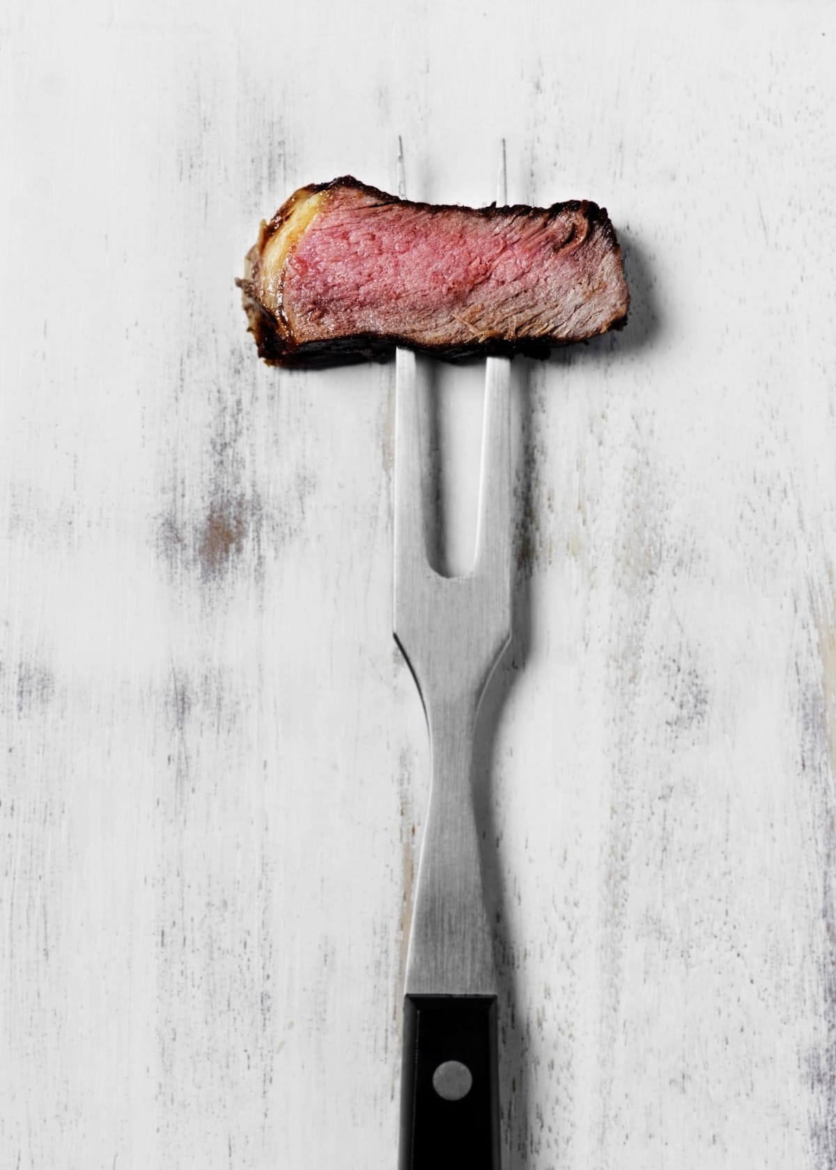 bite of steak on a fork