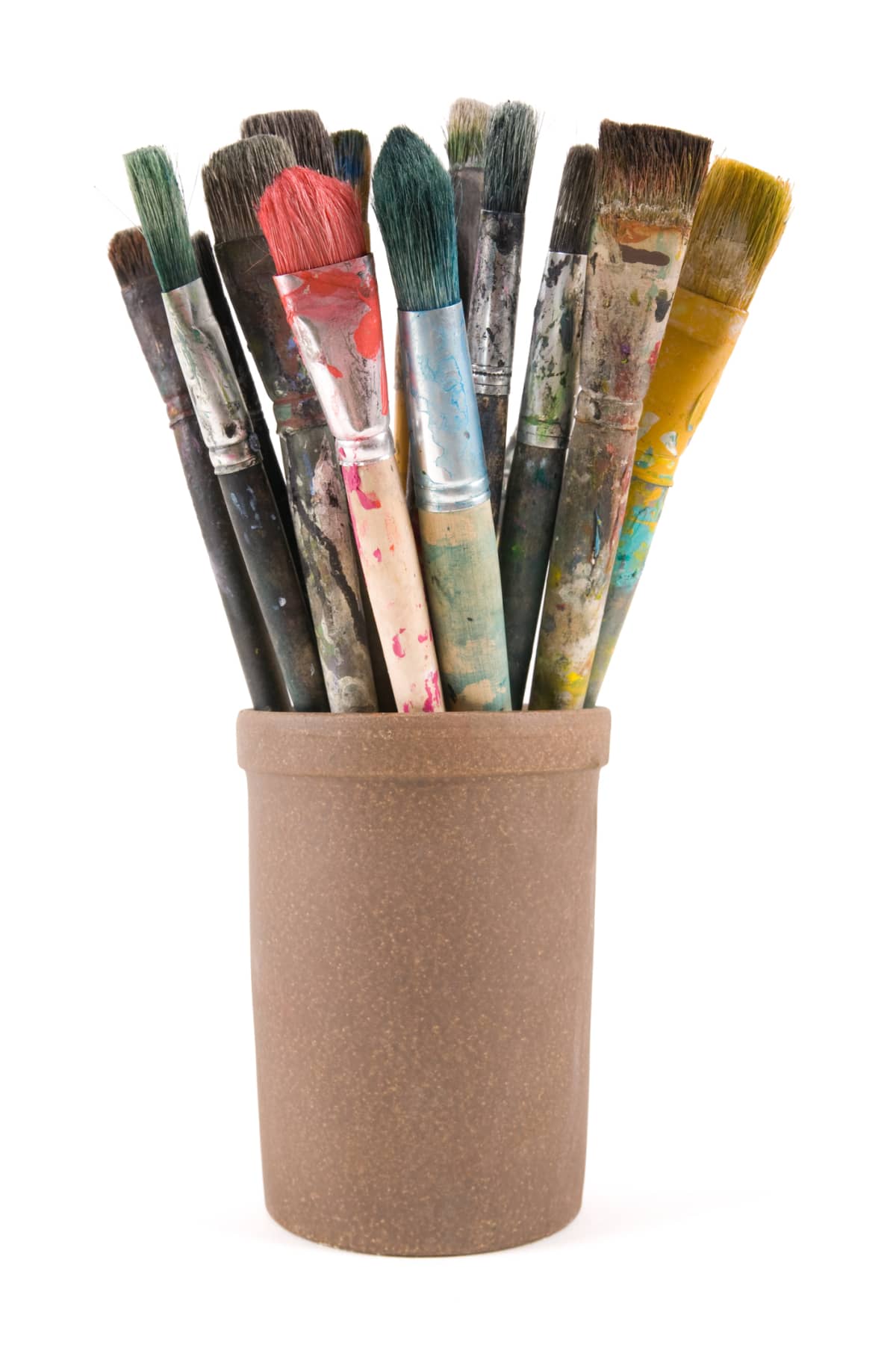 several dried paint brushes in a container