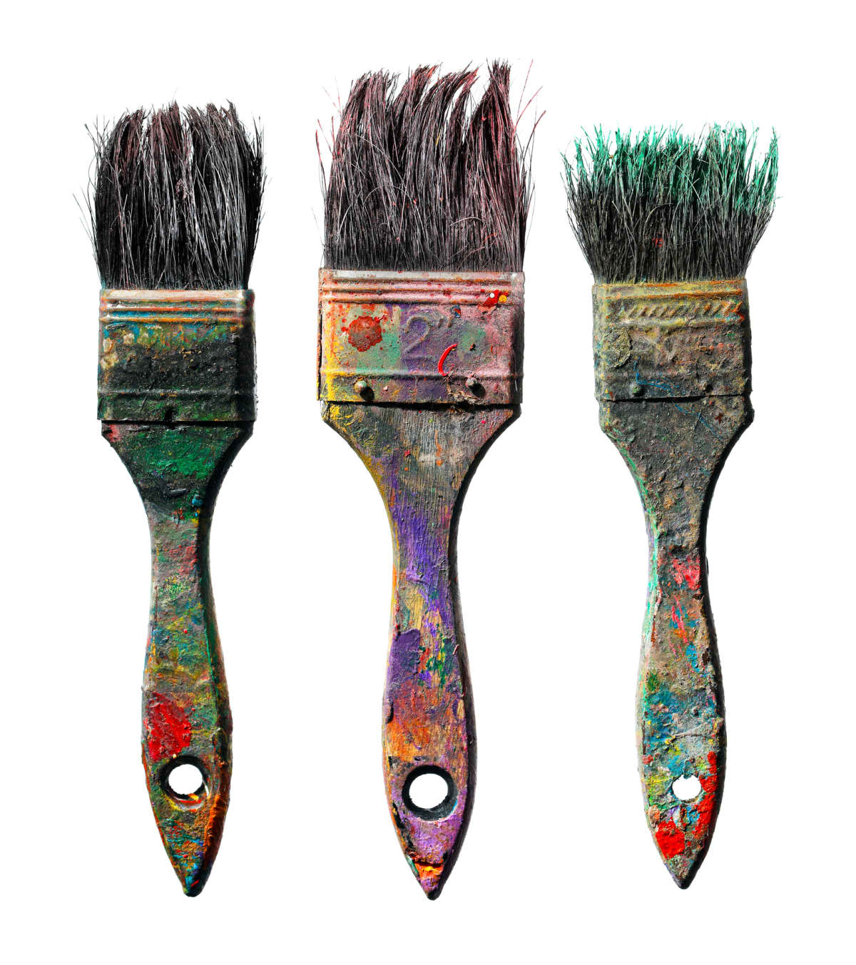 Dirty paint brushes against a white background