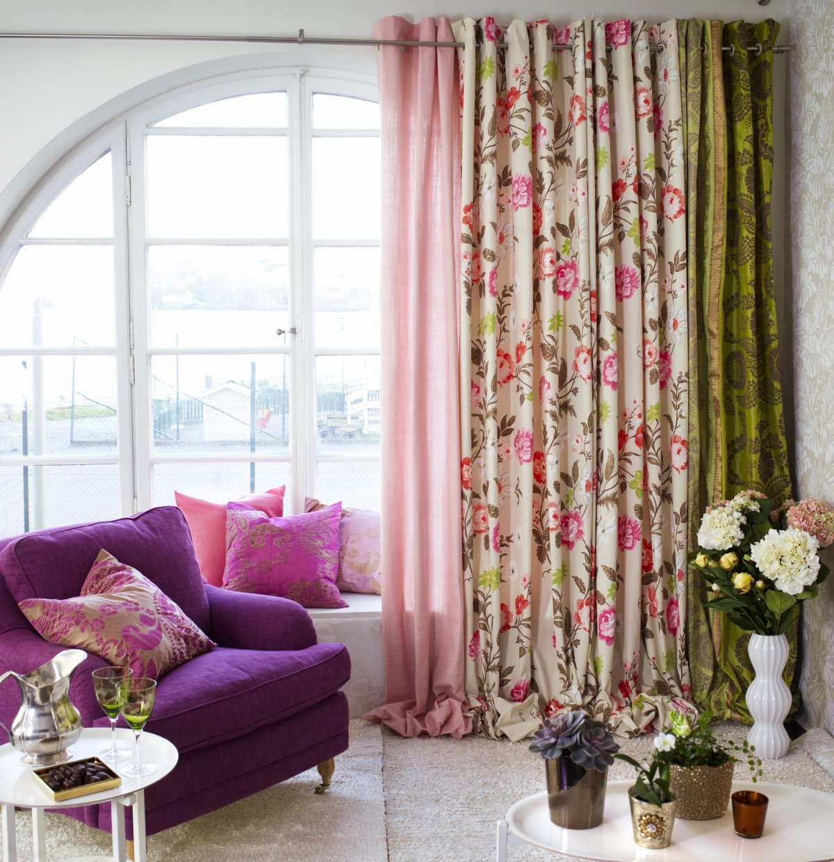 Bedroom with pink floral curtains and purple chair