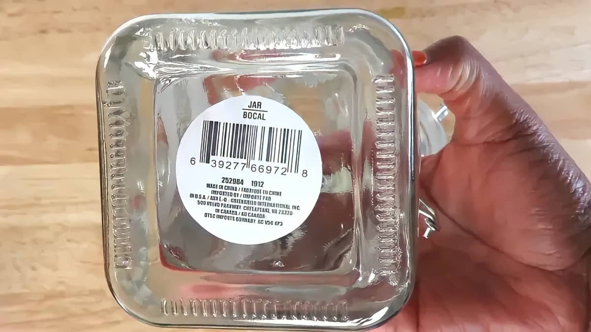 A large price tag on the bottom of a glass jar