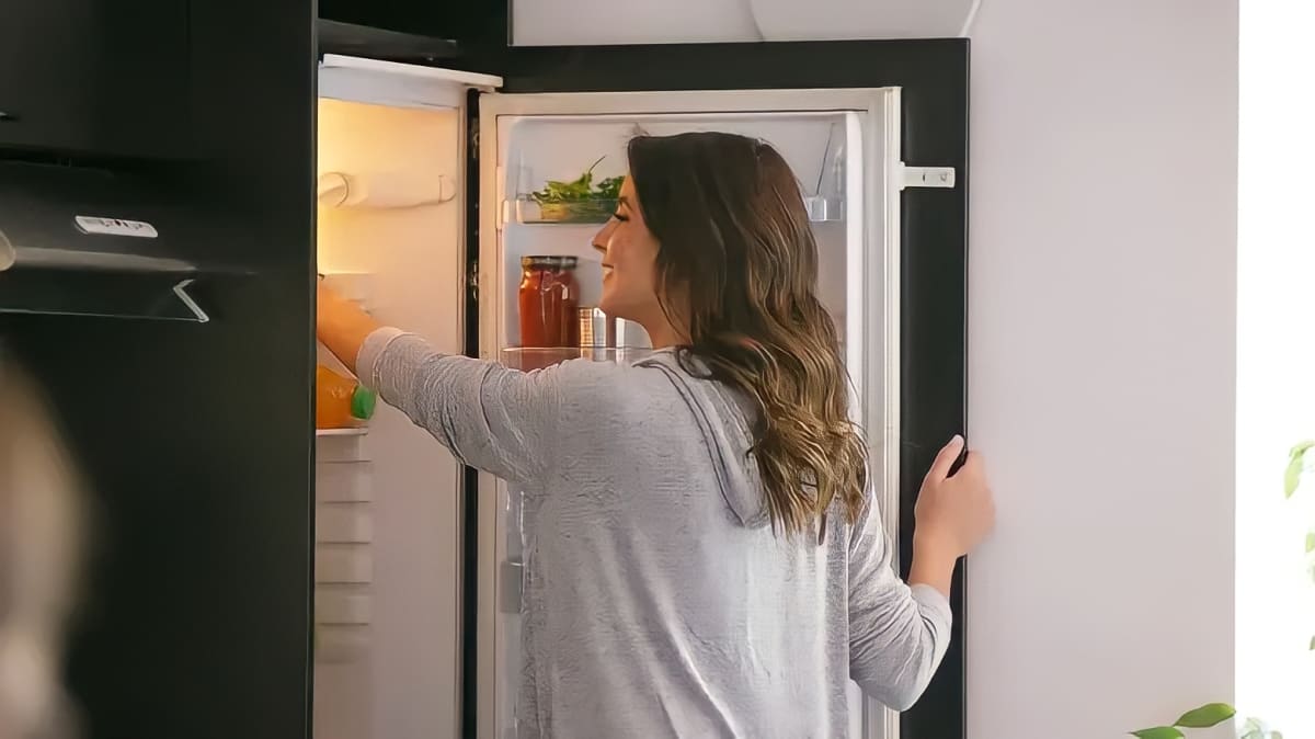 Woman organizing her fridge