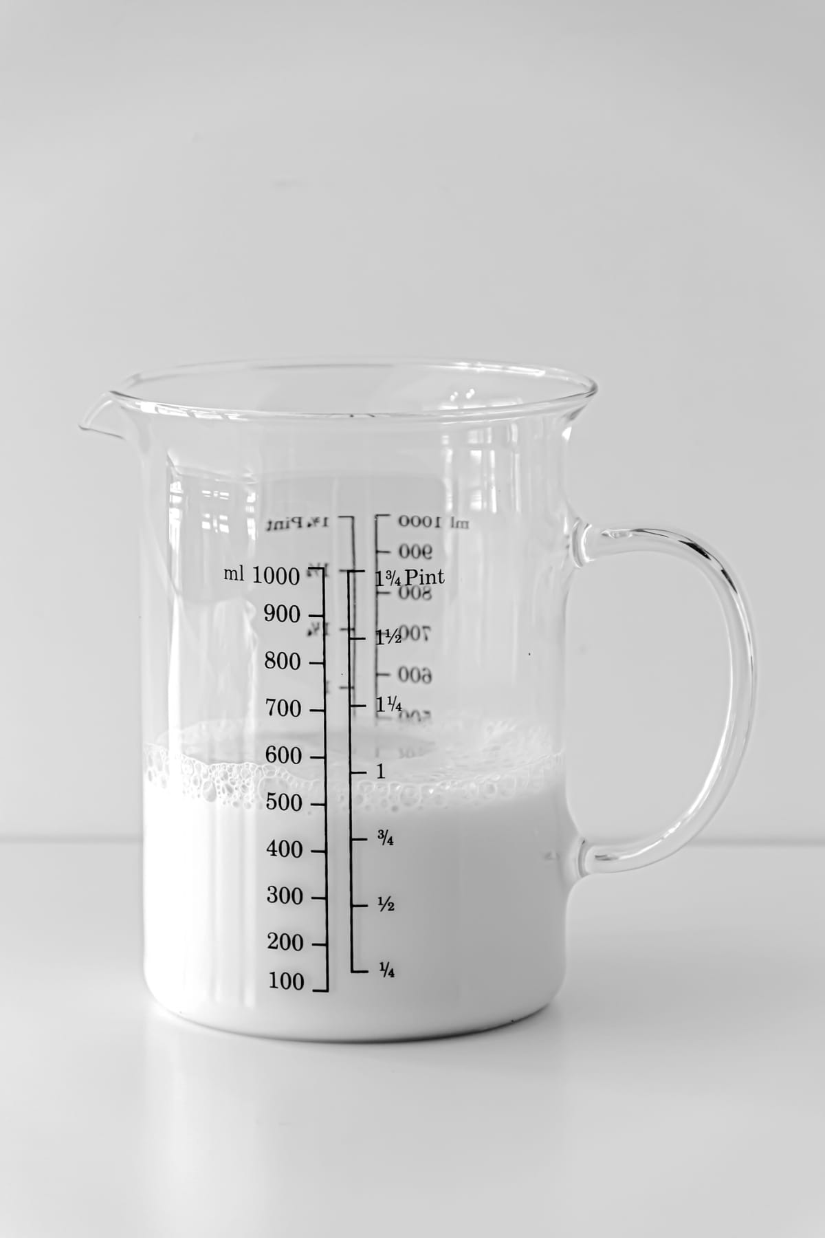 Whole milk in a liquid measuring jug