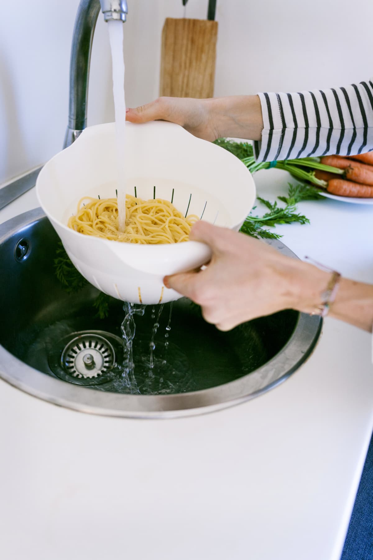 A woman draining pasta
