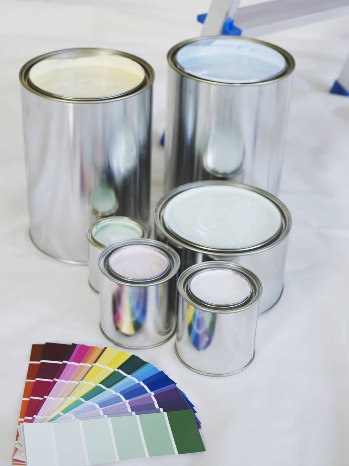 Paint cans and color samples on a white background