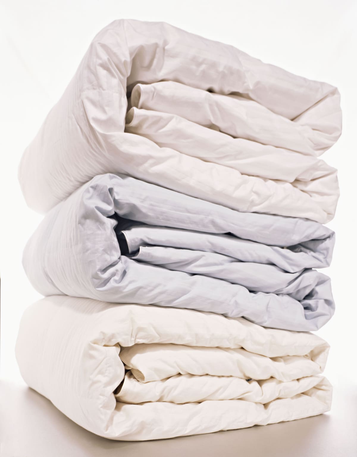 Down comforters stacked on top of each other