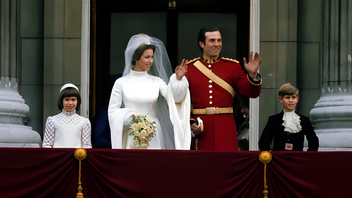 Princess Anne waves to the crowds from the royal balcony after her wedding