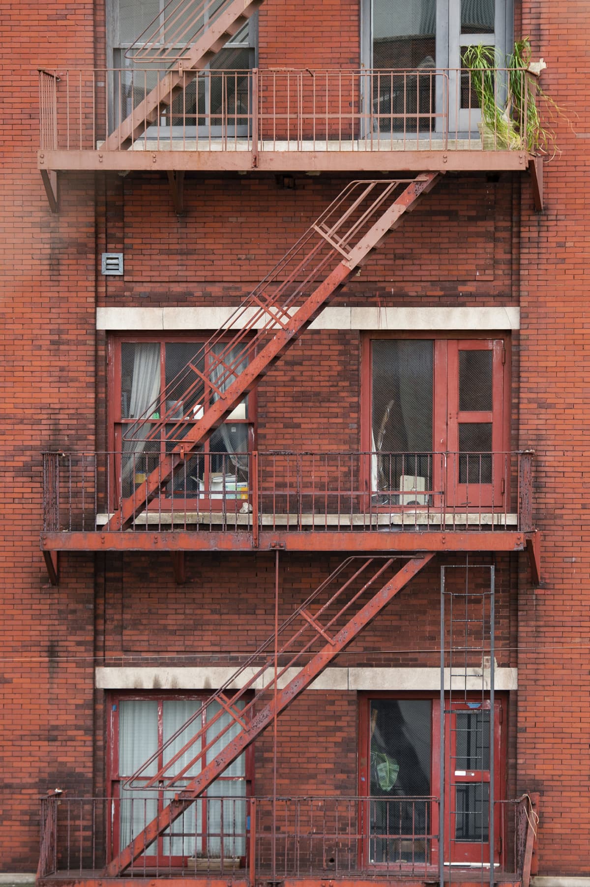 Fire ladders on historic red brick apartment building