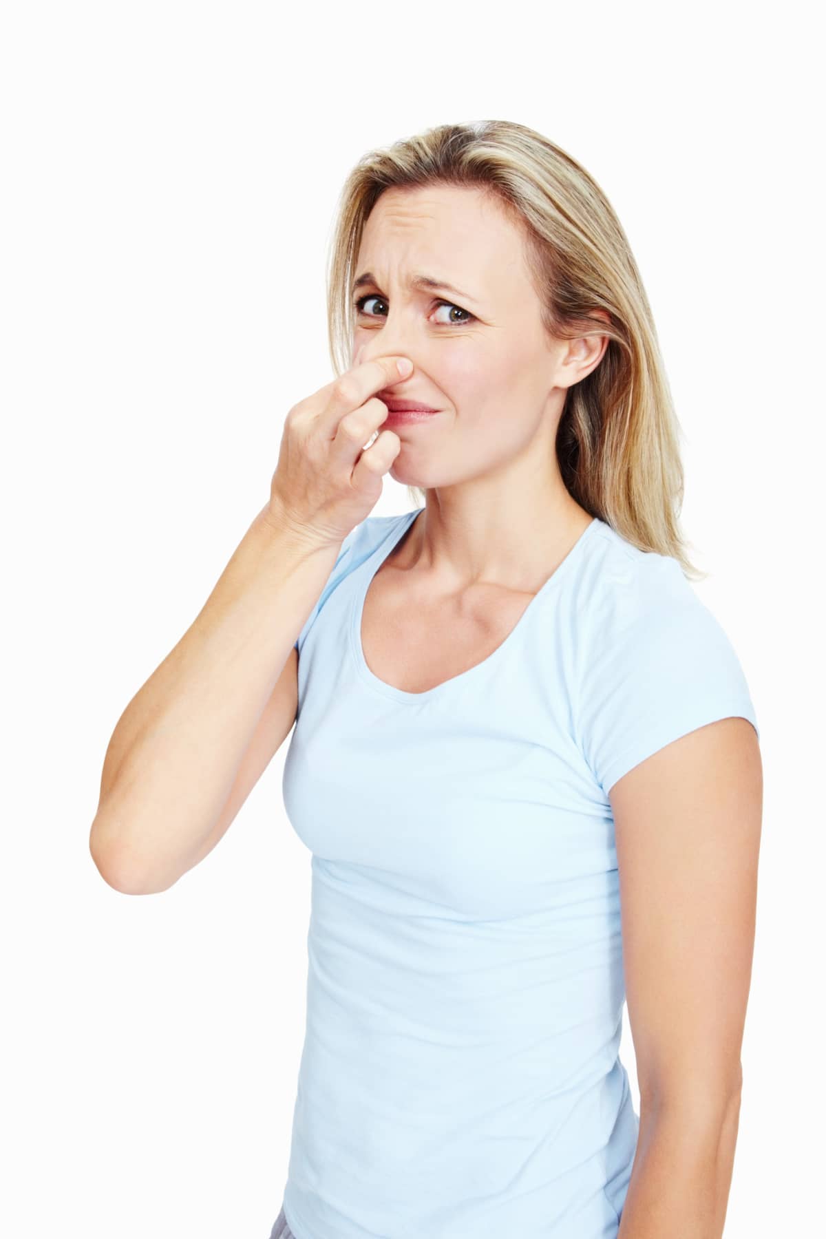 Woman pinching her nose in disgust