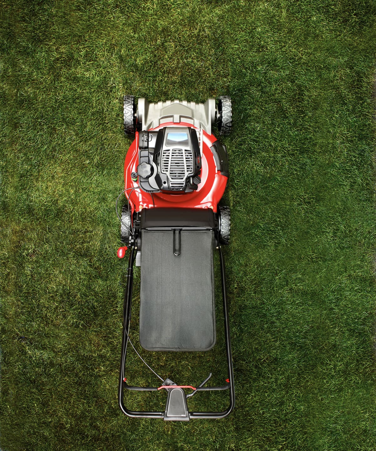A lawnmower mowing a lawn. 