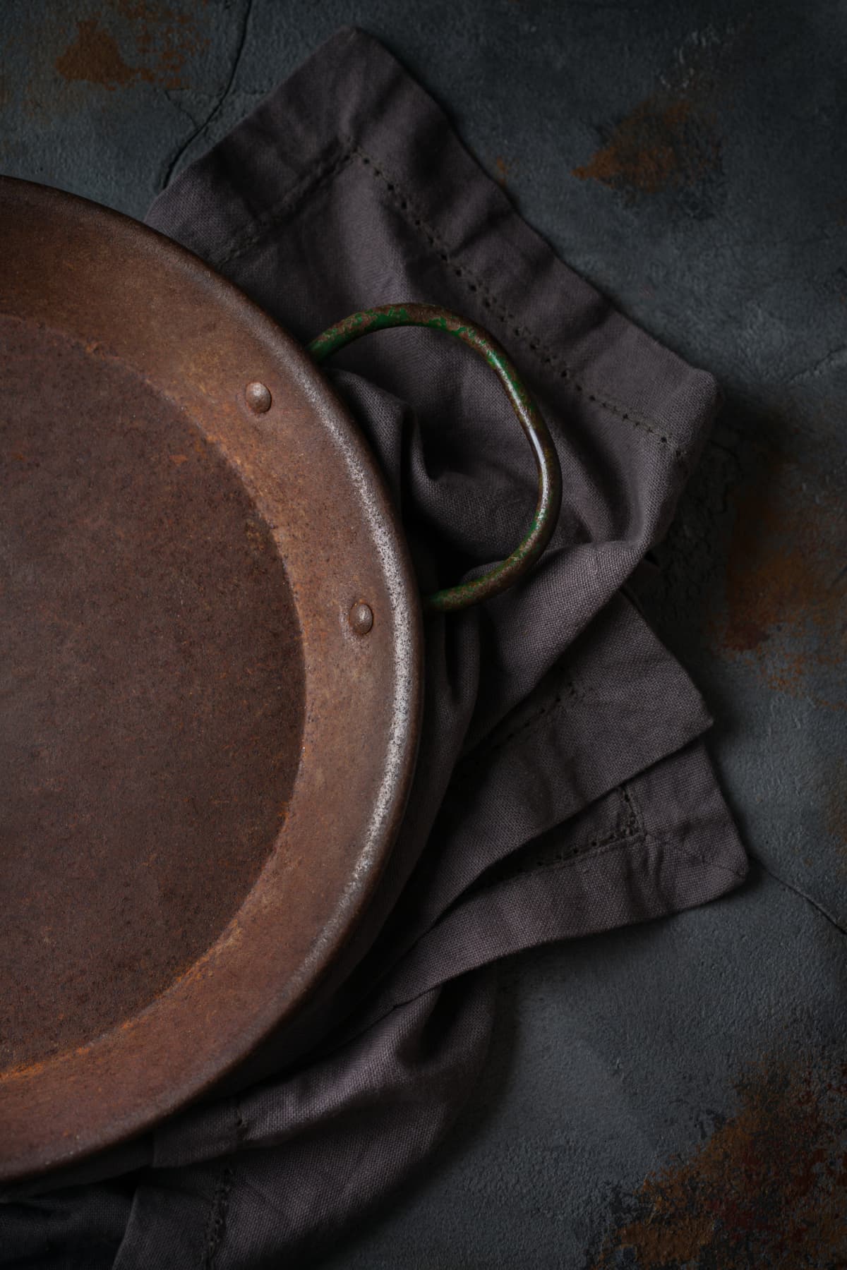 Food cooking concept. Empty cast iron frying roasting pan on a dark background. Flat lay, top view, copy space