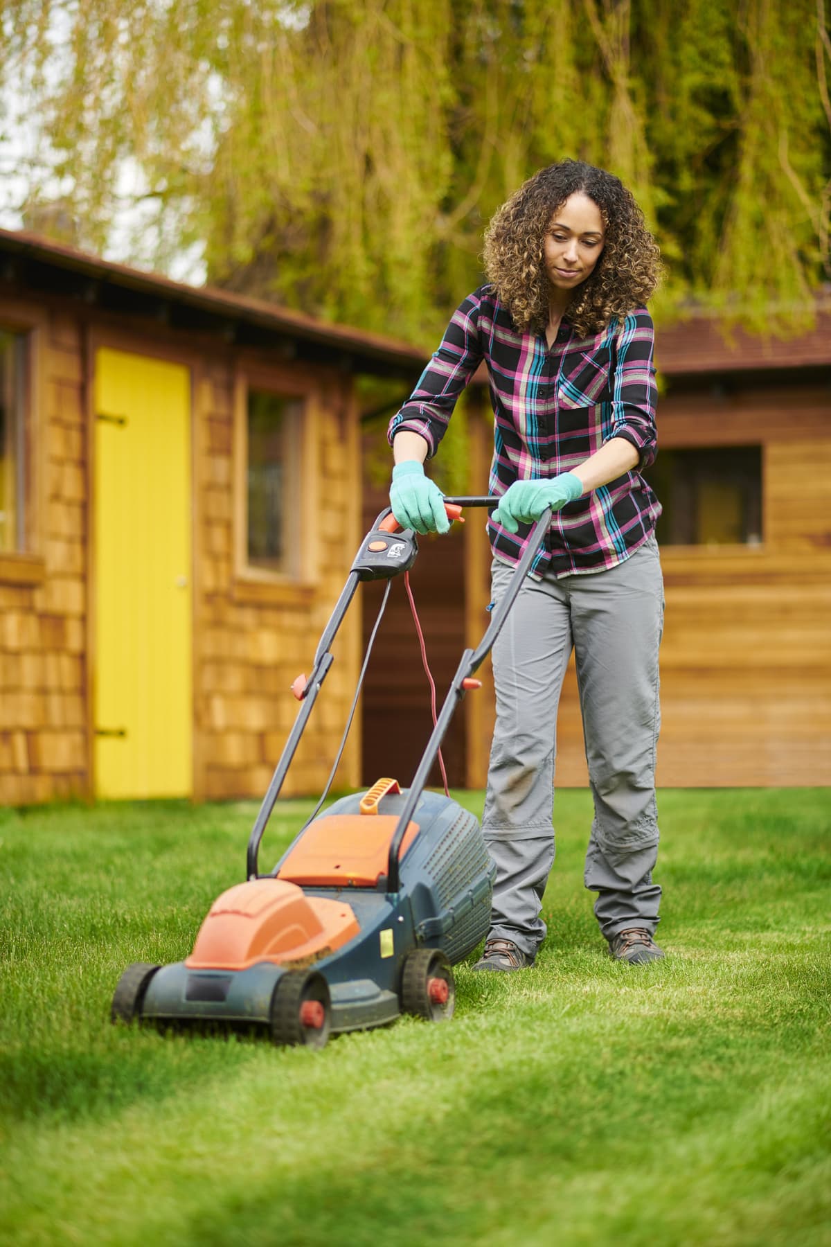 Woman mowing her lawn