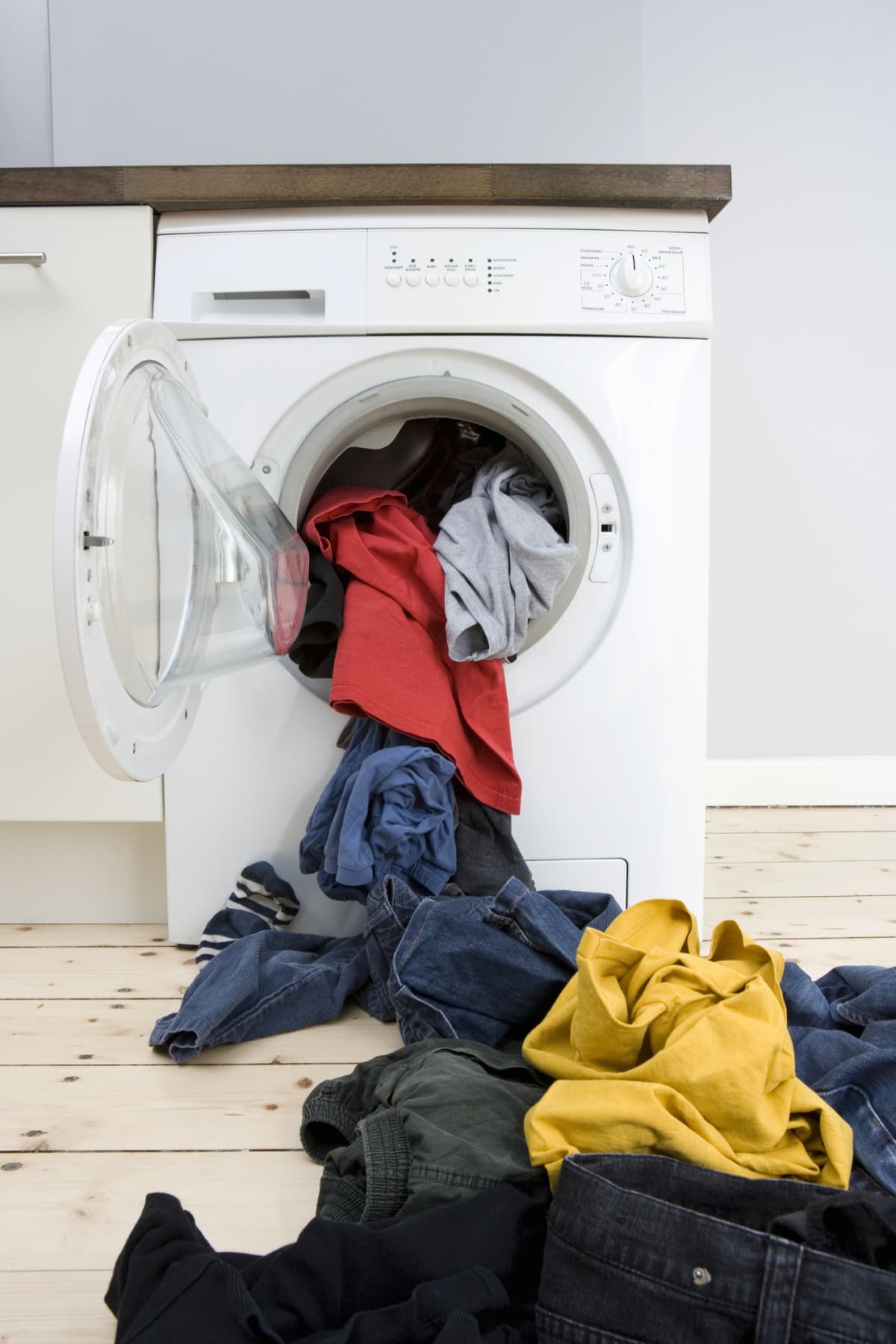Clothes spilling out of a washing machine