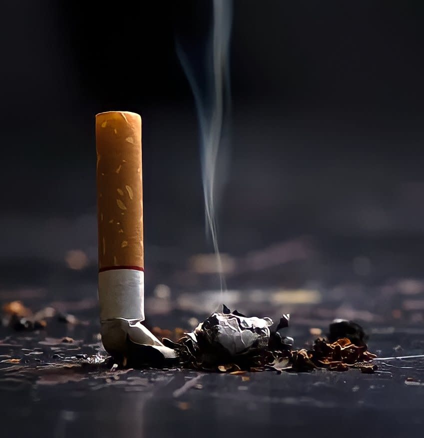 Cigarette snuffed out on a black surface
