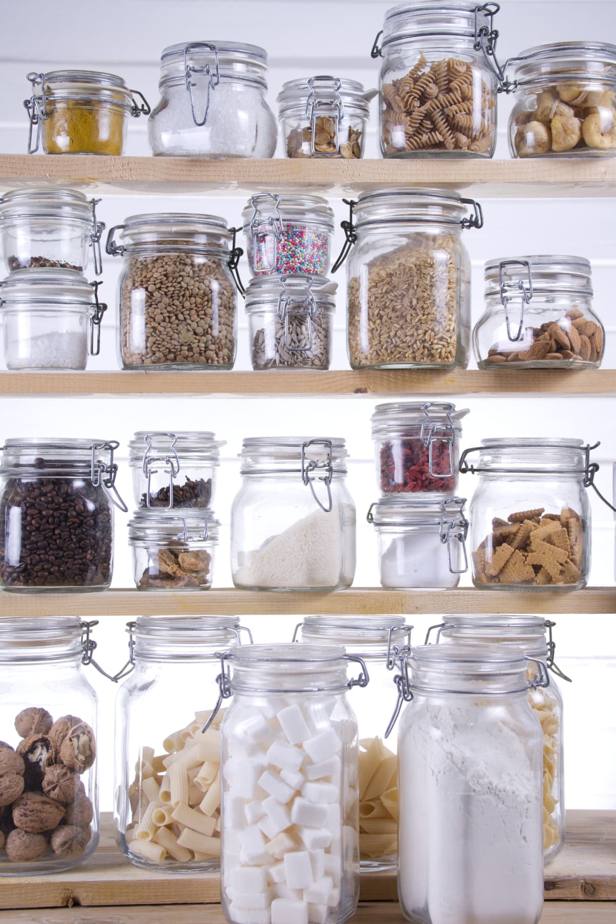Eclectic array of glass jars display foods in a kitchen pantry